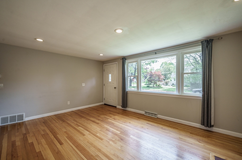 226 Dutchess Street Springfield, MA 01129 - Photo 15 of 39 an empty room with wooden floor and windows