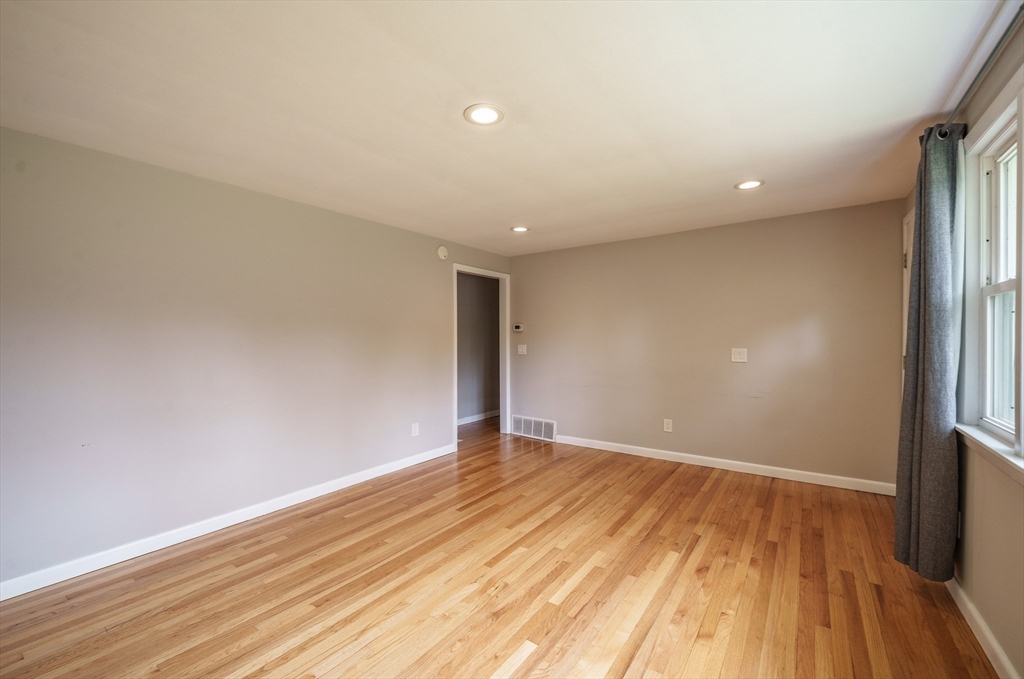 226 Dutchess Street Springfield, MA 01129 - Photo 16 of 39 a view of an empty room with wooden floor and a window
