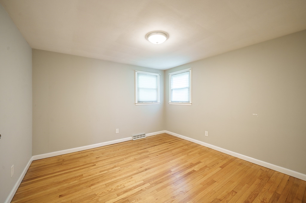 226 Dutchess Street Springfield, MA 01129 - Photo 24 of 39 a view of empty room with wooden floor and fan