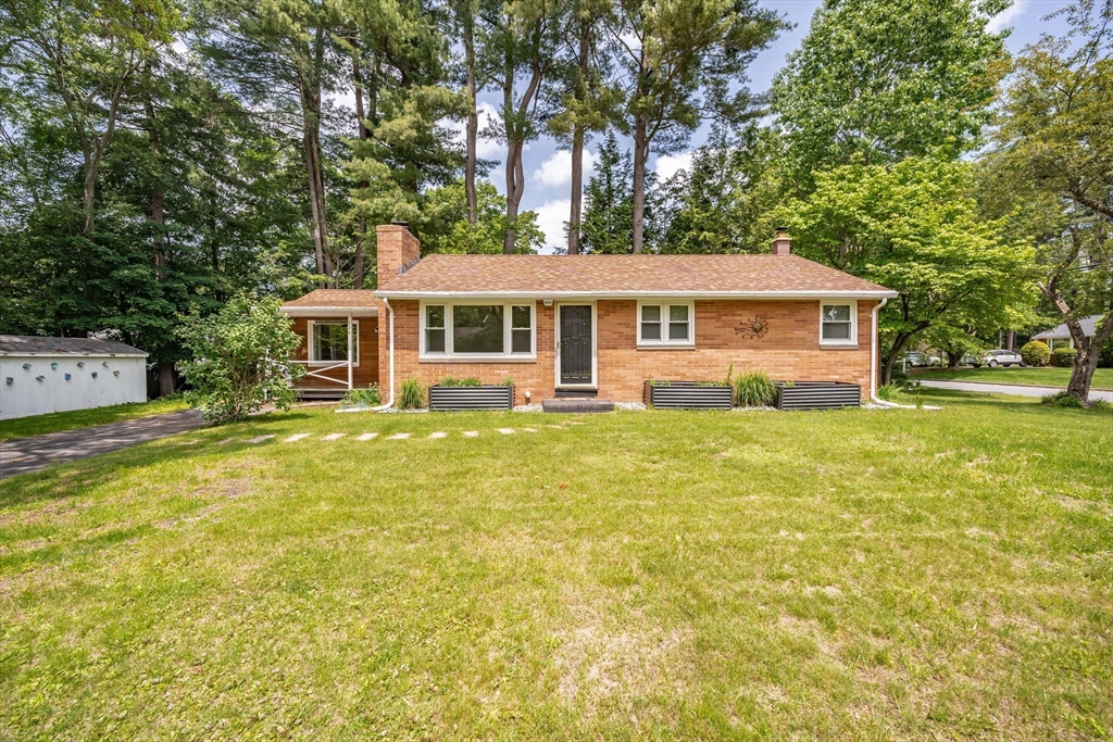 226 Dutchess Street Springfield, MA 01129 - Photo 35 of 39 a front view of a house with a yard table and chairs