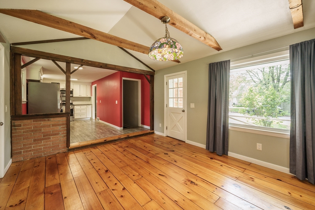226 Dutchess Street Springfield, MA 01129 - Photo 7 of 39 a view of a hallway with wooden floor and a chandelier