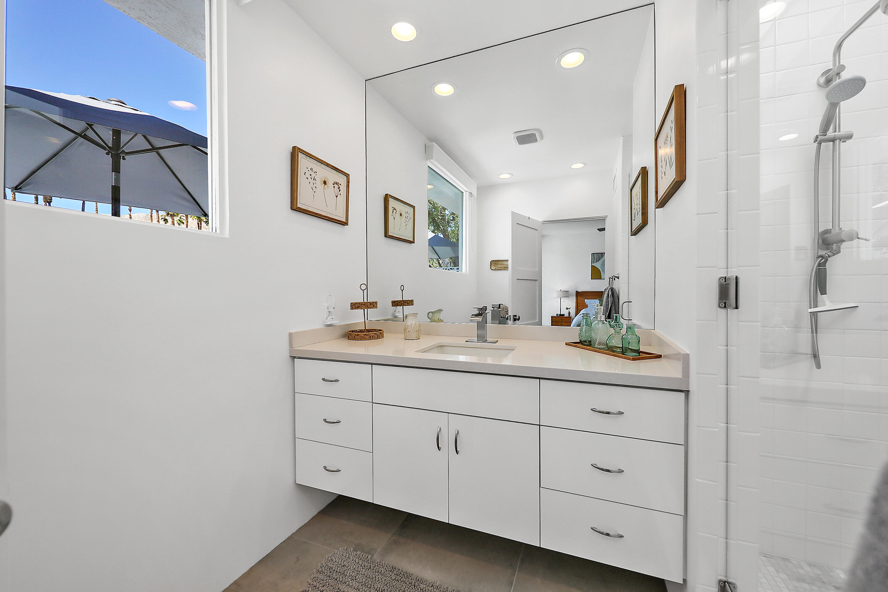 71350 Halgar Road Rancho Mirage, CA 92270 - Photo 22 of 33 a bathroom with a granite countertop sink vanity and mirror