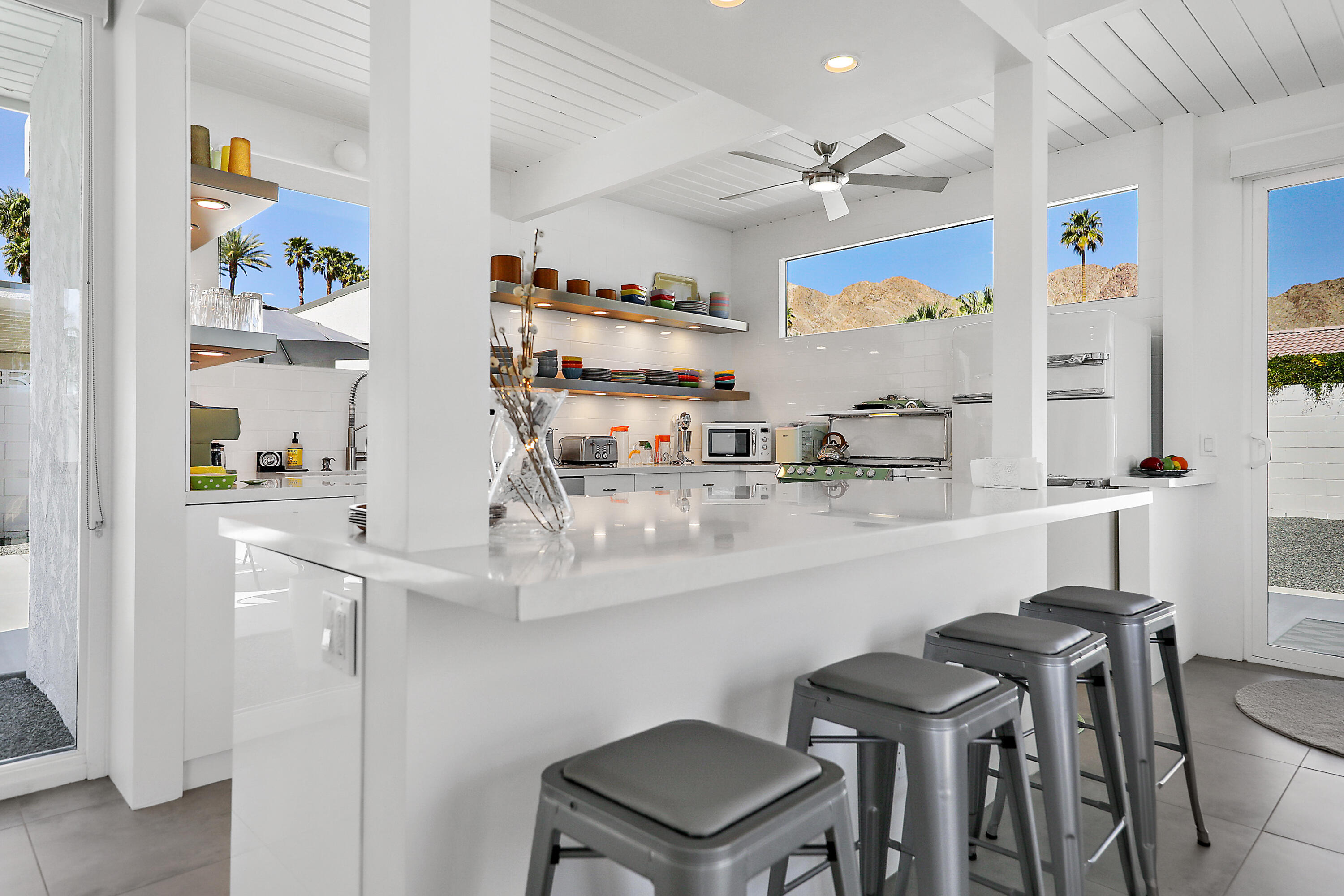 71350 Halgar Road Rancho Mirage, CA 92270 - Photo 6 of 33 a kitchen with stainless steel appliances a table and chairs in it