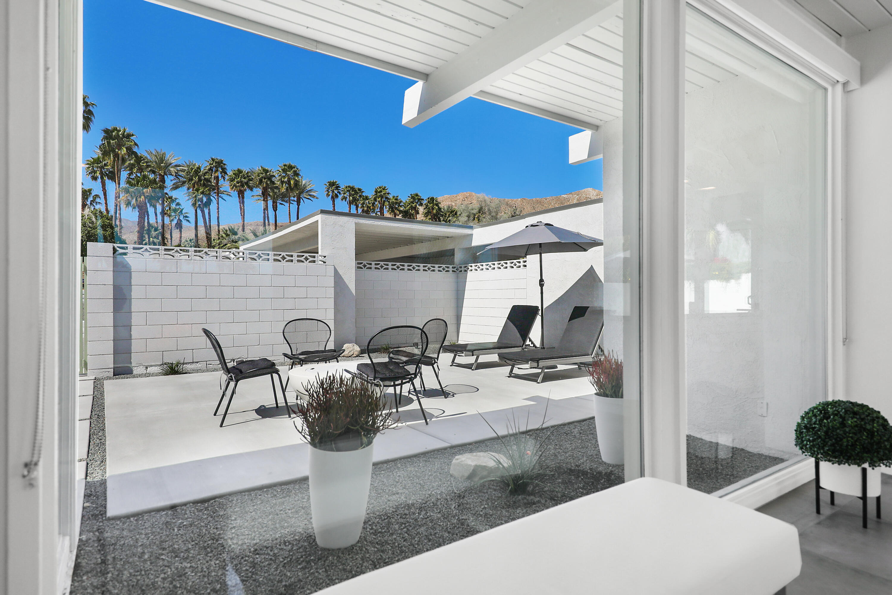 71350 Halgar Road Rancho Mirage, CA 92270 - Photo 8 of 33 a view of a dining room with furniture and a potted plant