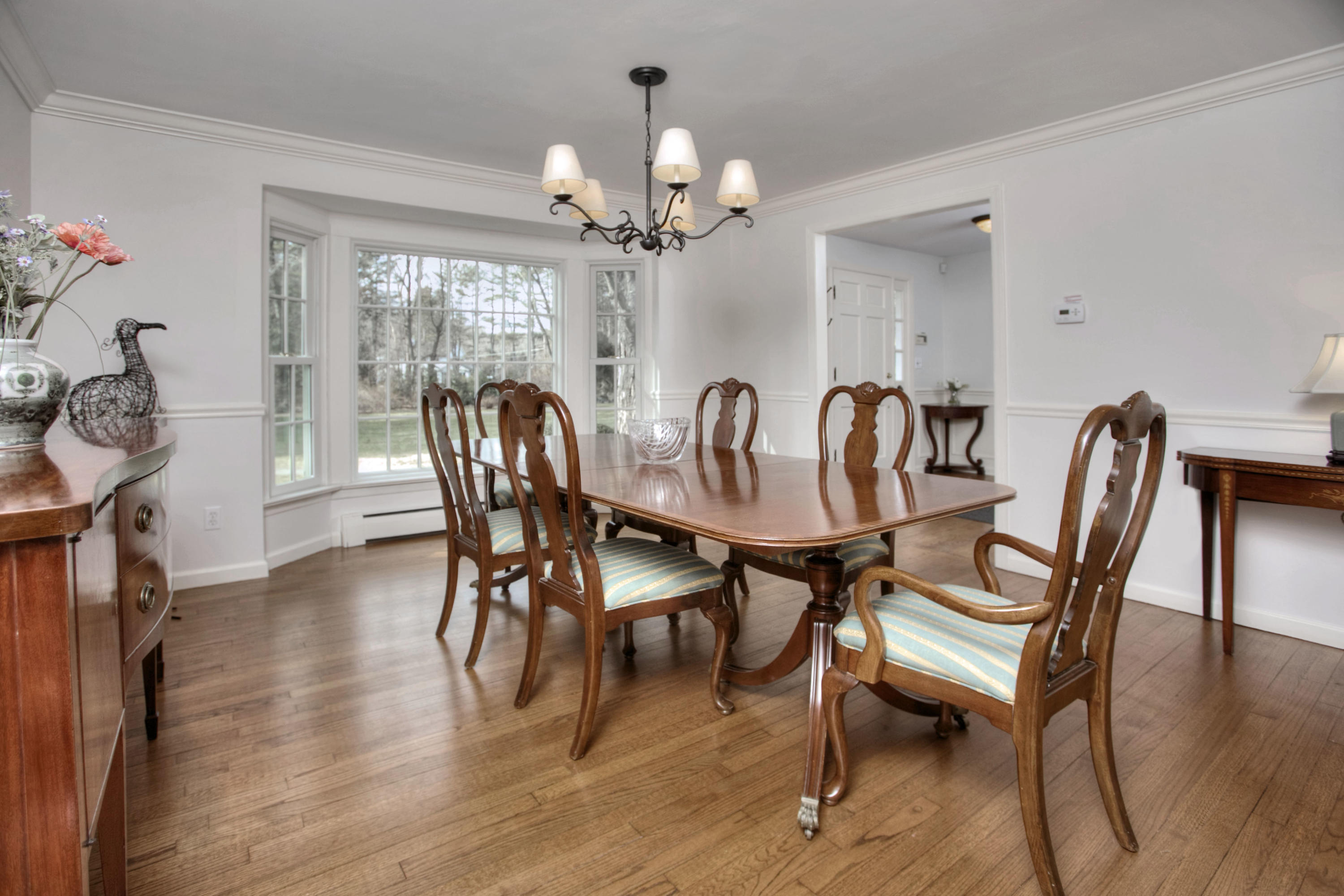 736 Silvermine Road New Canaan, CT 06840 - Photo 5 of 30 a dining room with furniture a chandelier and wooden floor