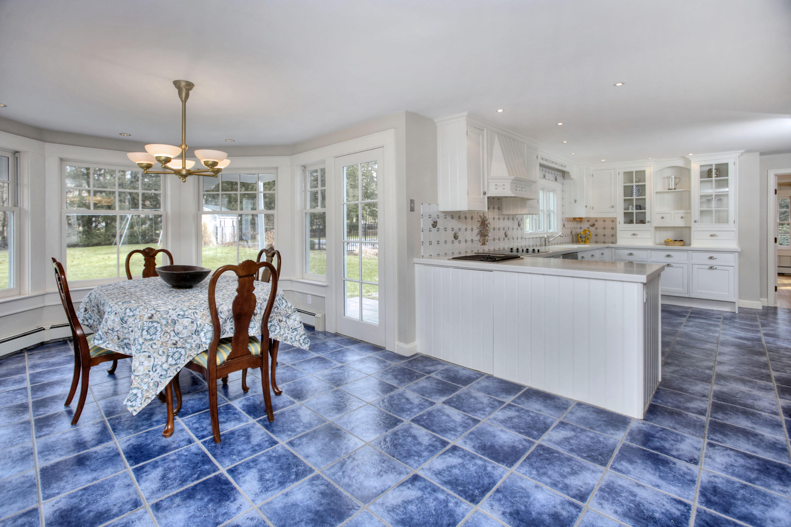736 Silvermine Road New Canaan, CT 06840 - Photo 8 of 30 a dining room with furniture a chandelier and wooden floor