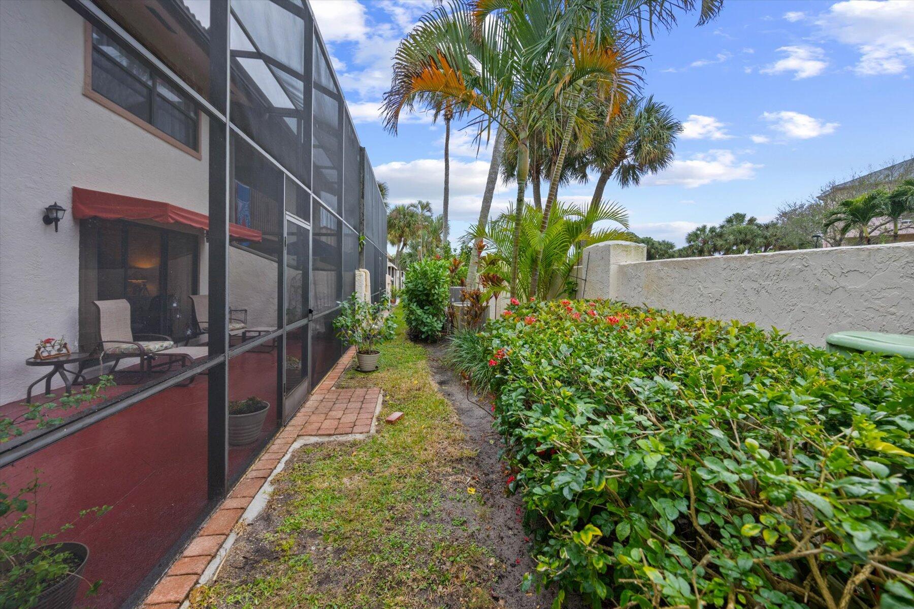 130 Palm Avenue, Unit 20 Jupiter, FL 33477 - Photo 16 of 51 a backyard of a house with lots of green space