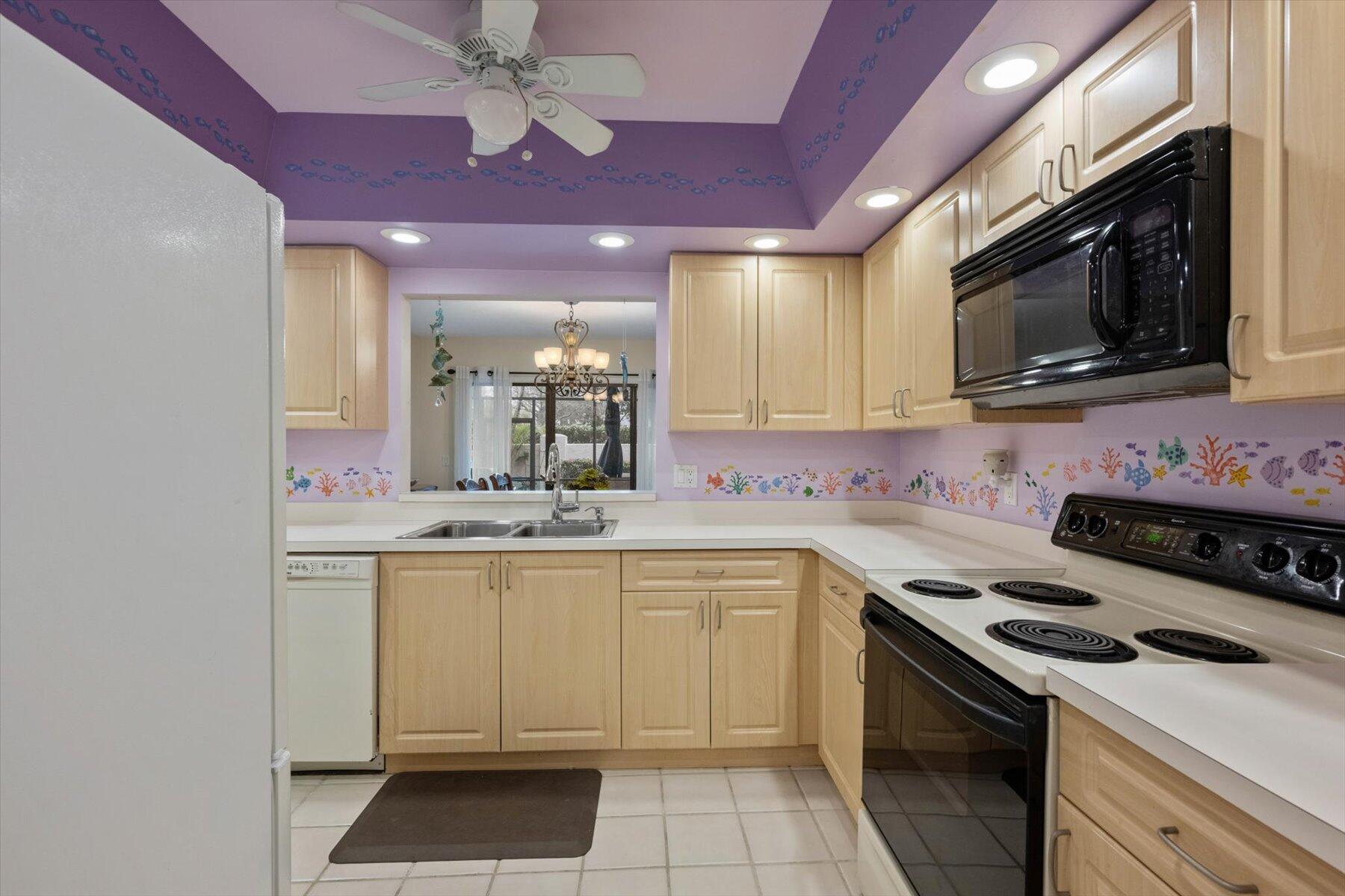 130 Palm Avenue, Unit 20 Jupiter, FL 33477 - Photo 19 of 51 a kitchen with a sink stove and microwave