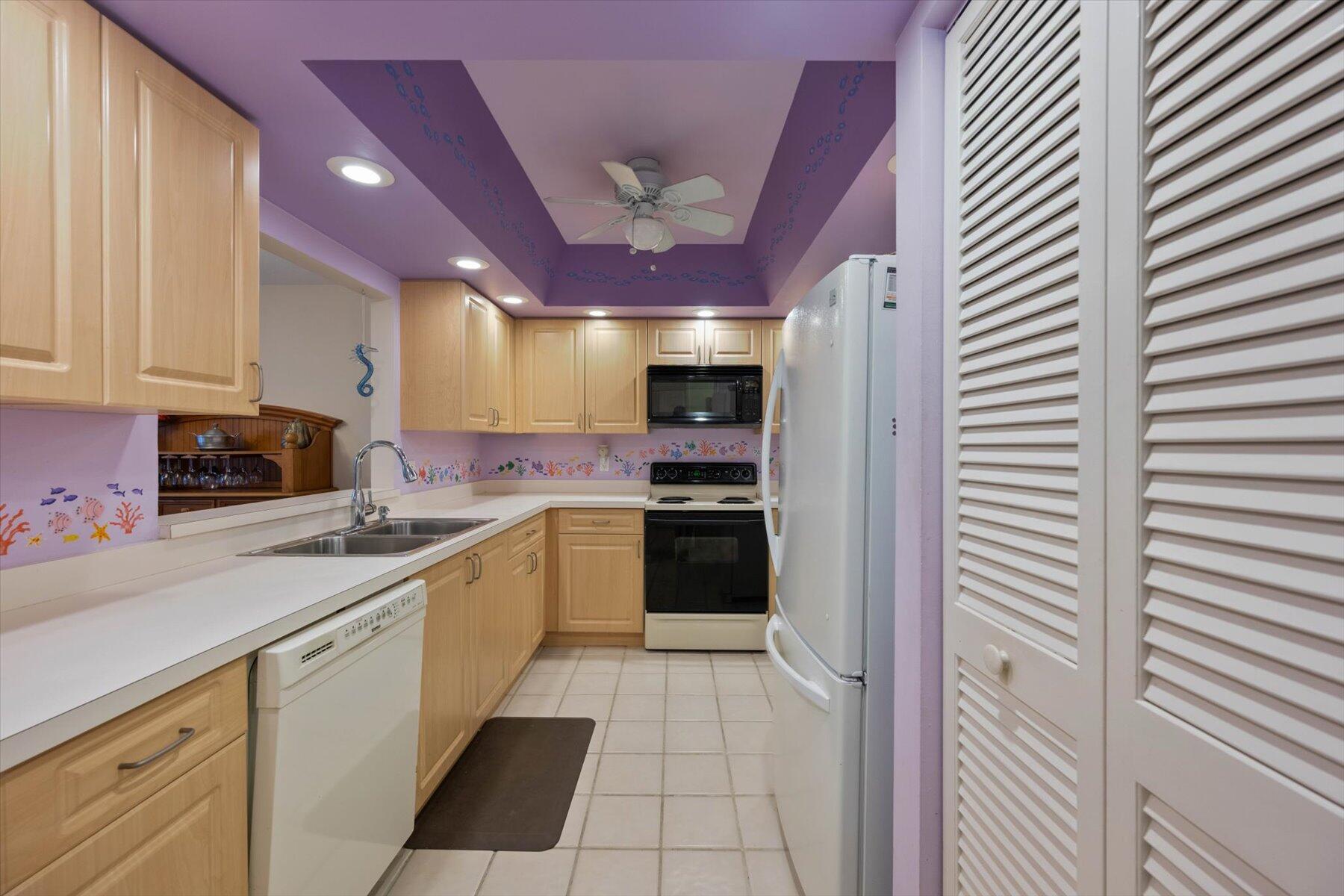 130 Palm Avenue, Unit 20 Jupiter, FL 33477 - Photo 21 of 51 a kitchen with stainless steel appliances granite countertop a refrigerator and a stove top oven