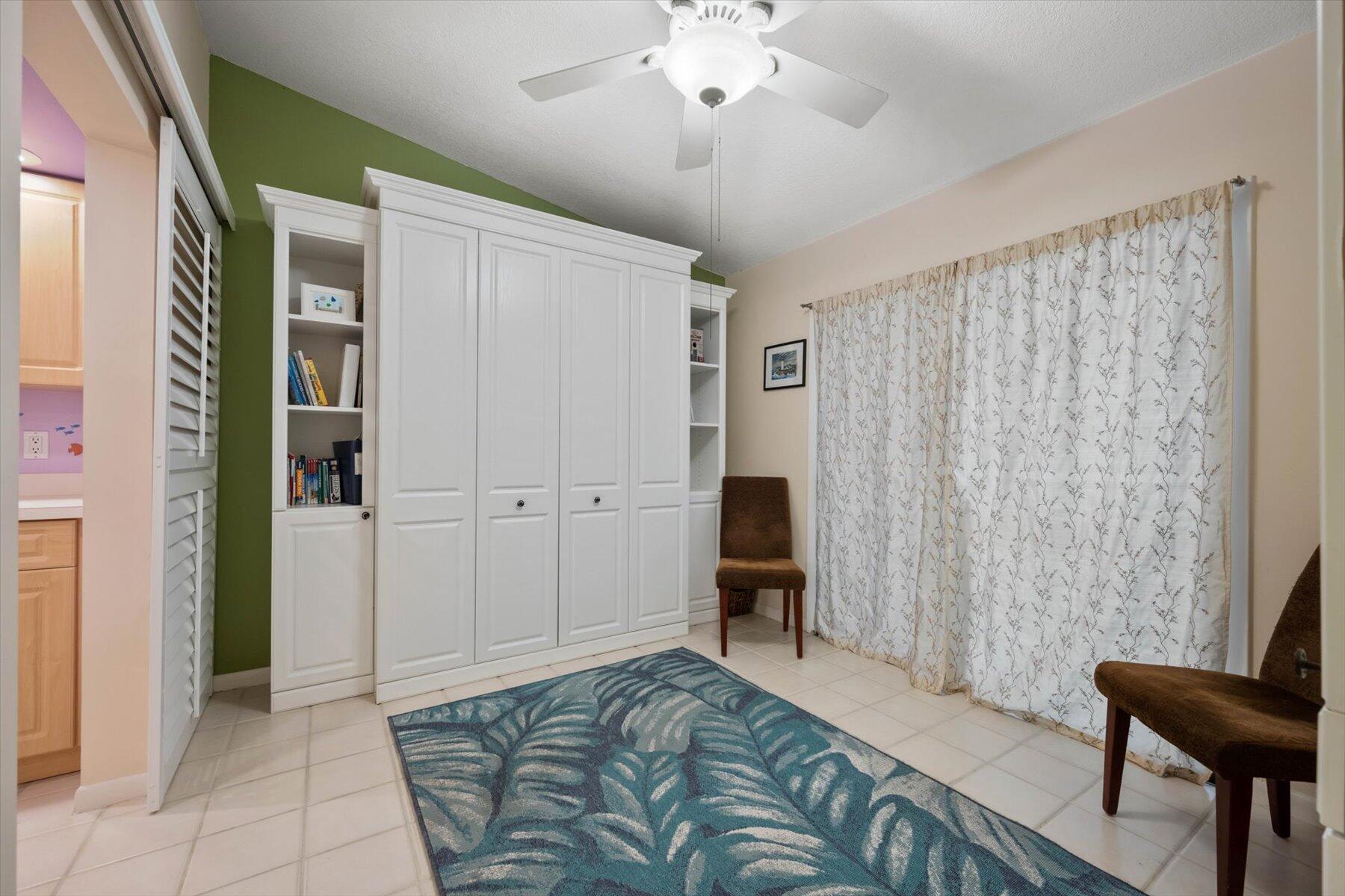 130 Palm Avenue, Unit 20 Jupiter, FL 33477 - Photo 24 of 51 a bedroom with a bed and a chair