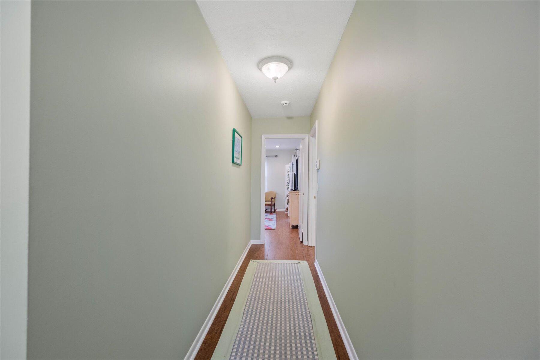 130 Palm Avenue, Unit 20 Jupiter, FL 33477 - Photo 30 of 51 a view of a hallway with wooden floor