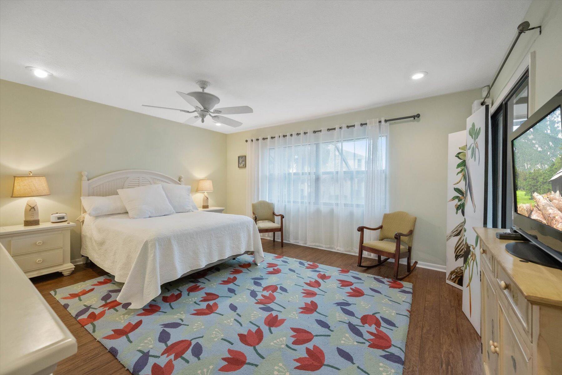 130 Palm Avenue, Unit 20 Jupiter, FL 33477 - Photo 31 of 51 a bedroom with a bed and a flat screen tv