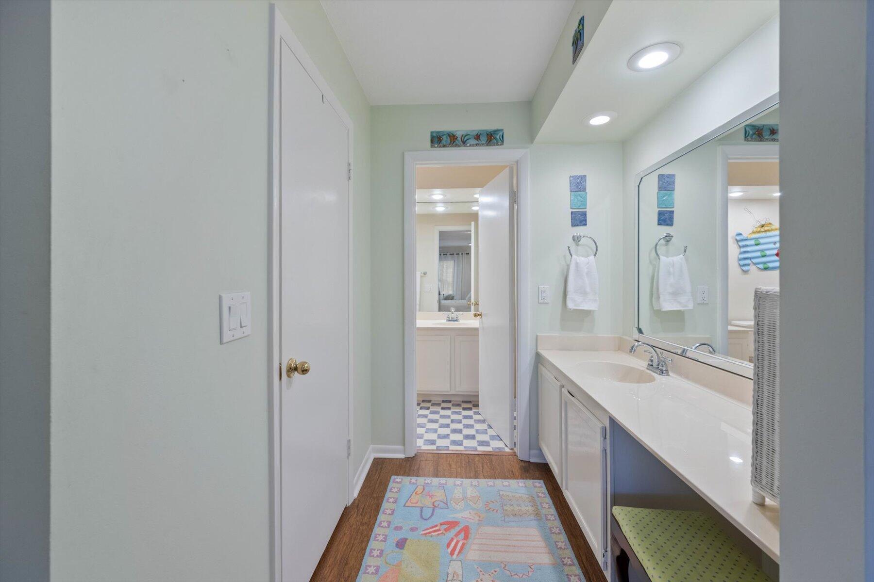 130 Palm Avenue, Unit 20 Jupiter, FL 33477 - Photo 34 of 51 a bathroom with a sink a mirror and a bathtub