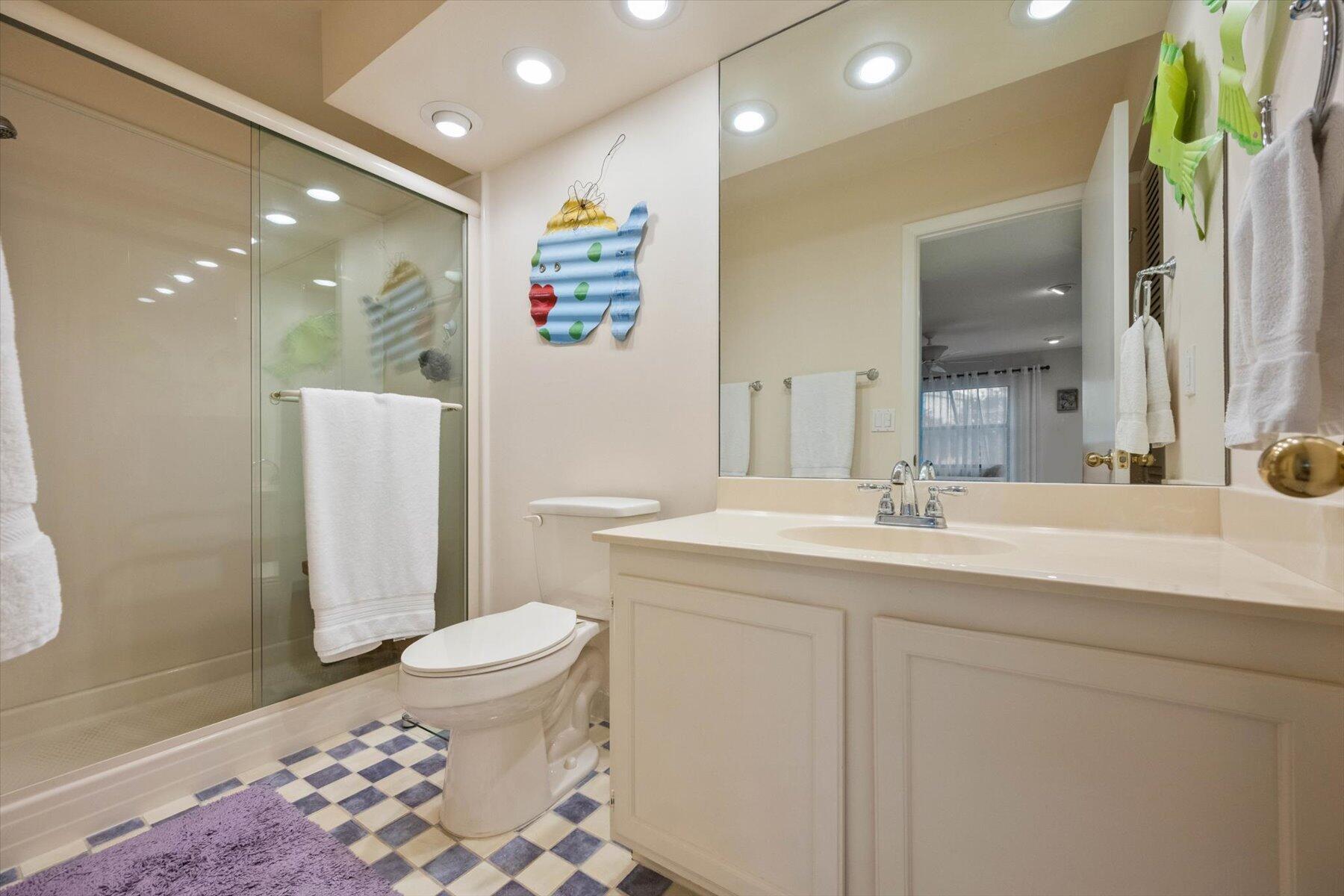 130 Palm Avenue, Unit 20 Jupiter, FL 33477 - Photo 35 of 51 a bathroom with a sink a toilet a shower and a mirror