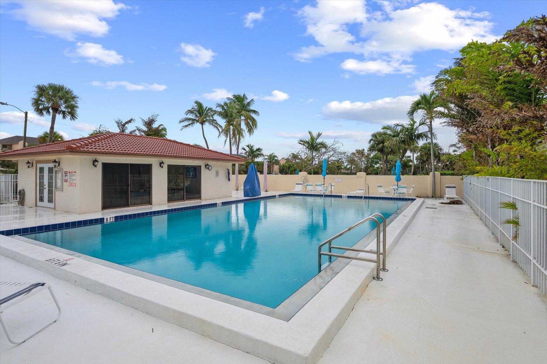 130 Palm Avenue, Unit 20 Jupiter, FL 33477 - Photo 44 of 51 a view of a swimming pool with a yard