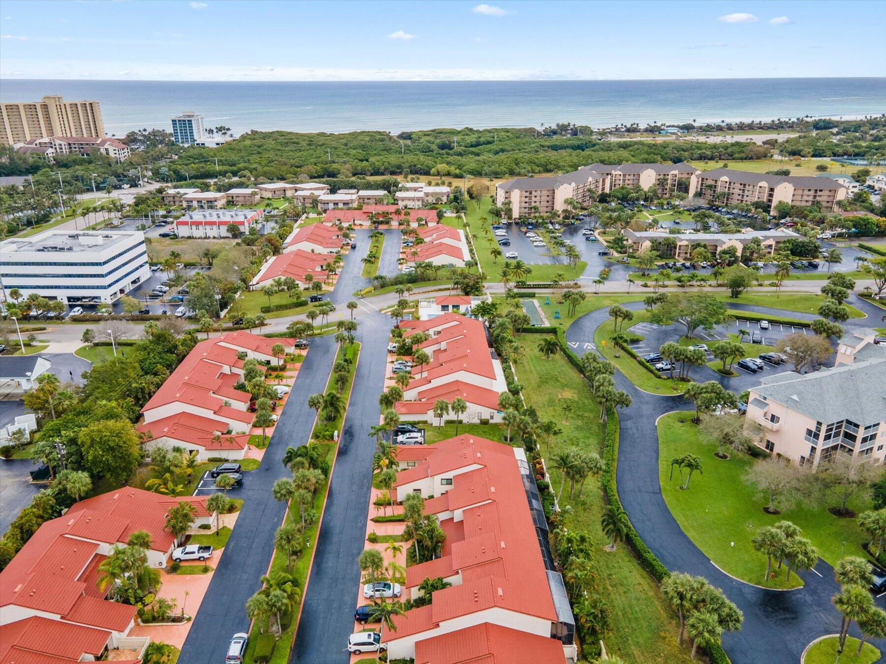 130 Palm Avenue, Unit 20 Jupiter, FL 33477 - Photo 48 of 51 an aerial view of residential houses with outdoor space