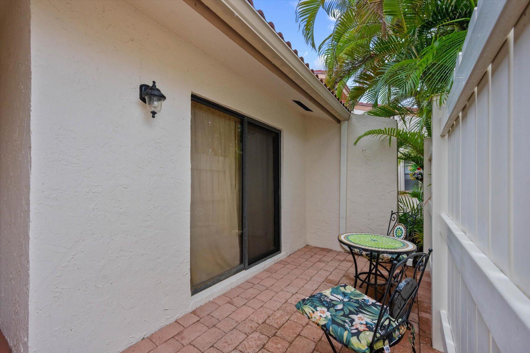 130 Palm Avenue, Unit 20 Jupiter, FL 33477 - Photo 5 of 51 a view of a porch with furniture and a potted plant