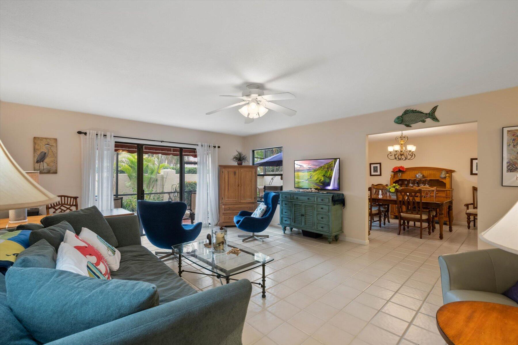 130 Palm Avenue, Unit 20 Jupiter, FL 33477 - Photo 9 of 51 a living room with furniture and a flat screen tv
