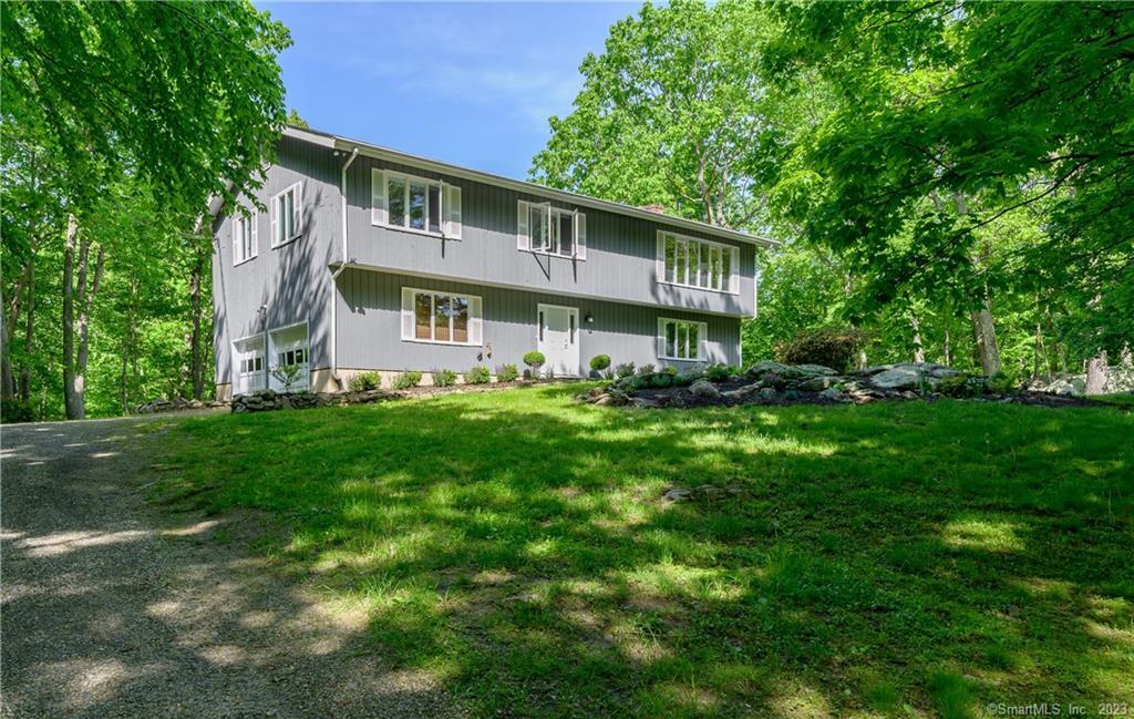 6 Valley Forge Lane Weston, CT 06883 - Photo 1 of 1 a front view of a house with a yard
