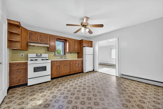 a kitchen with a stove a sink and a refrigerator