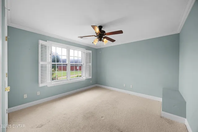 a view of a livingroom with a ceiling fan and window