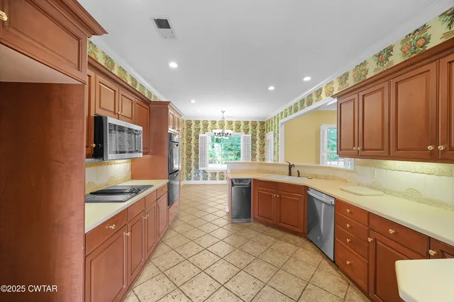a kitchen with stainless steel appliances granite countertop a sink and cabinets