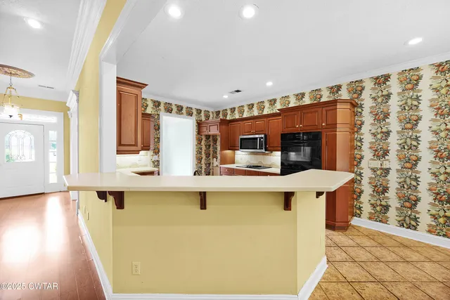 a kitchen with stainless steel appliances a sink and a refrigerator