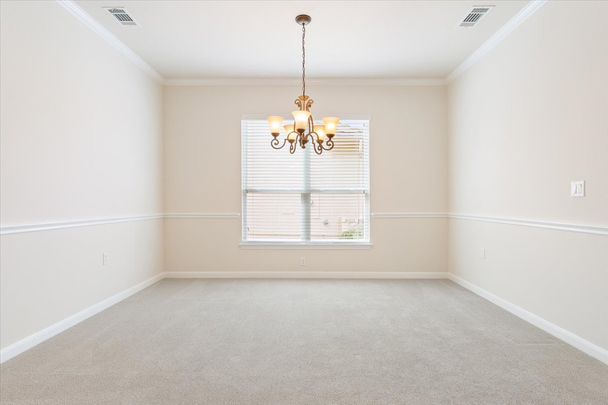 308 Monarch Trail Georgetown, TX 78633 - Photo 10 of 39 The bright formal dining room has crown molding, a char rail and chandalier.
