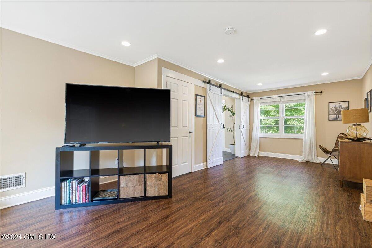 70 Gregory Road Cos Cob, CT 06807 - Photo 22 of 39 a living room with furniture wooden floor and a flat screen tv