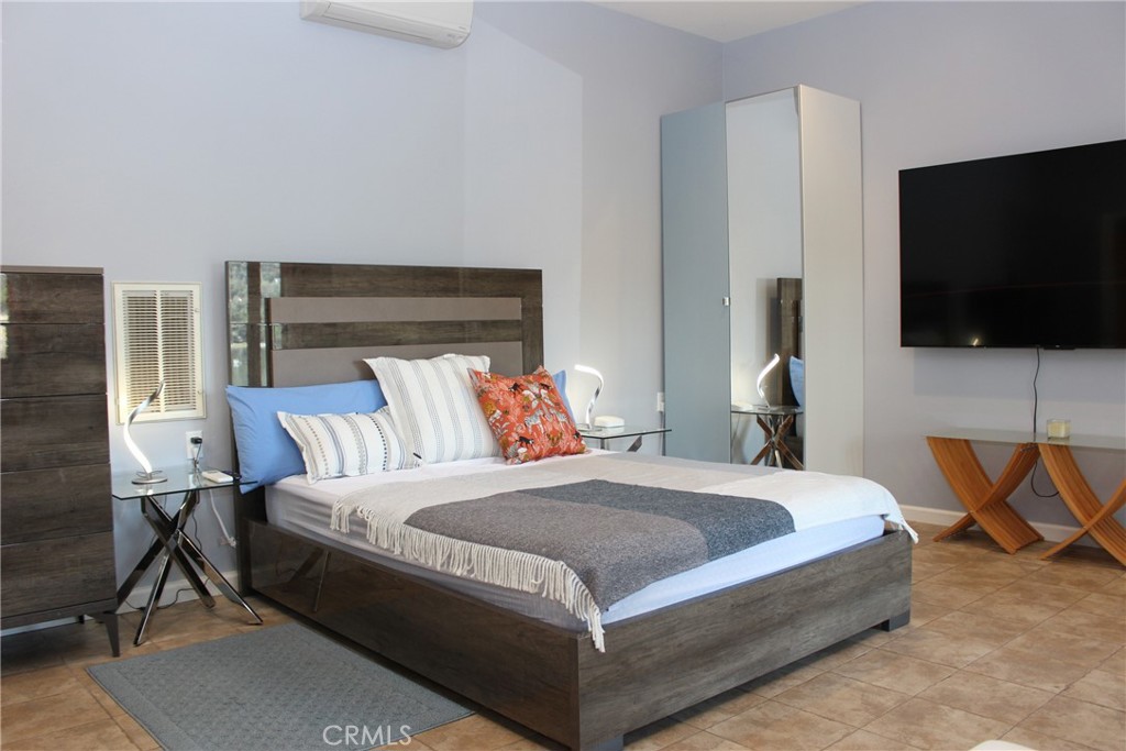 18702 East Ridge View Drive Hidden Valley Lake, CA 95467 - Photo 15 of 18 a bedroom with a bed and a flat screen tv