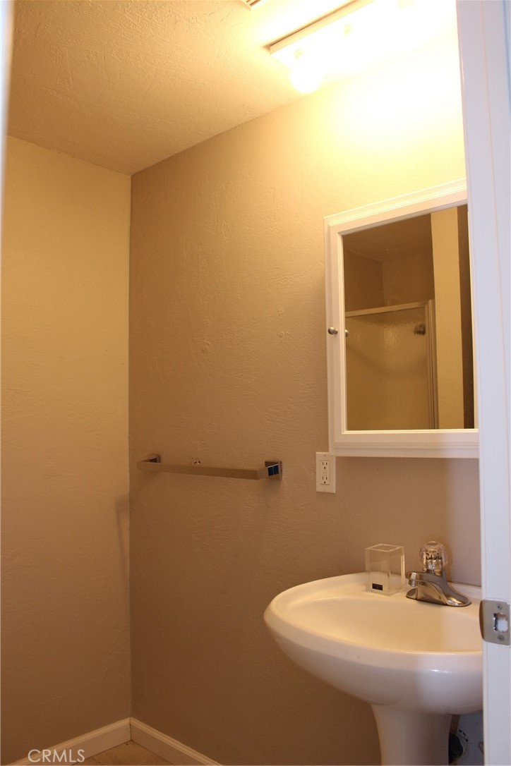 18702 East Ridge View Drive Hidden Valley Lake, CA 95467 - Photo 16 of 18 a bathroom with a sink and a mirror