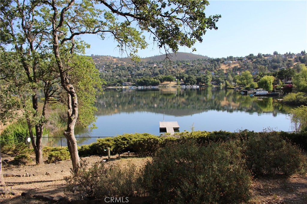 18702 East Ridge View Drive Hidden Valley Lake, CA 95467 - Photo 2 of 18 a view of a lake in between two large trees