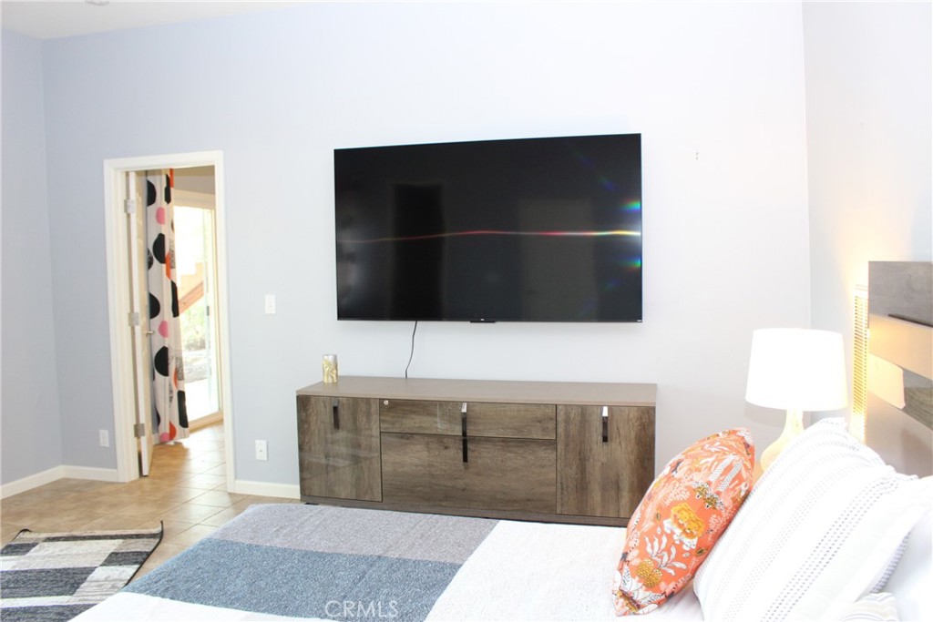 18702 East Ridge View Drive Hidden Valley Lake, CA 95467 - Photo 8 of 18 a living room with a bed and a flat screen tv
