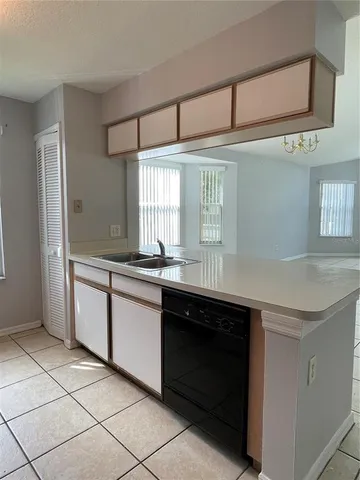 a kitchen with a sink cabinets and window