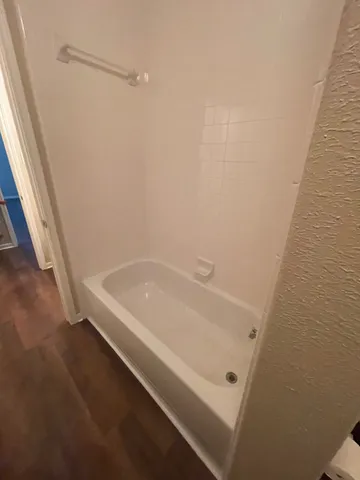 a bathroom with a tub and shower