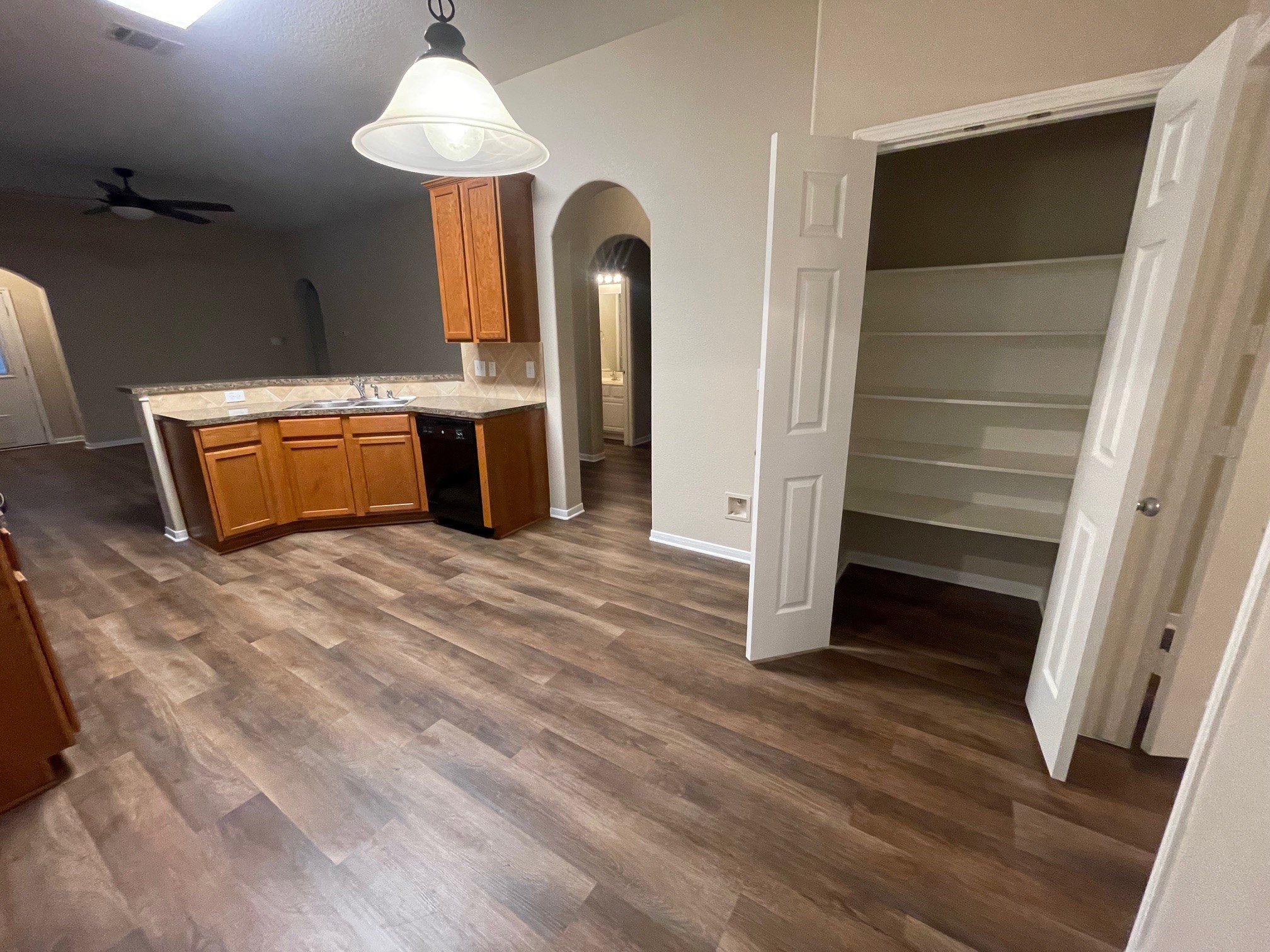 1201 Stallion Ridge Alvin, TX 77511 - Photo 26 of 29 a room with kitchen island stainless steel appliances wooden floor and window
