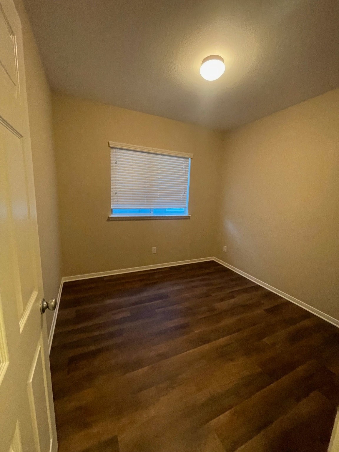 1201 Stallion Ridge Alvin, TX 77511 - Photo 8 of 29 a view of an empty room with wooden floor and a window