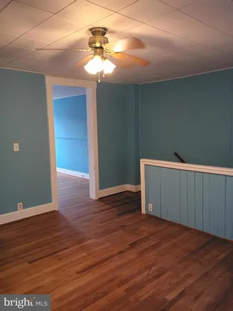 a view of a room with wooden floor