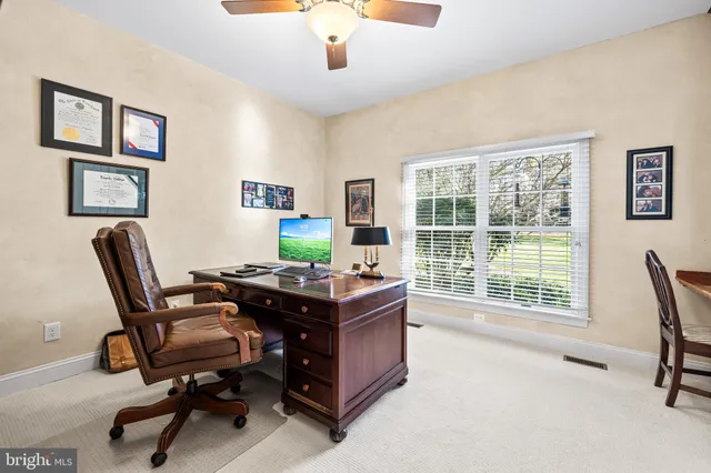 a bathroom with a granite countertop sink toilet and mirror