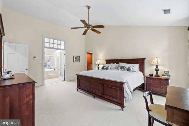 a bedroom with a large bed and a chandelier