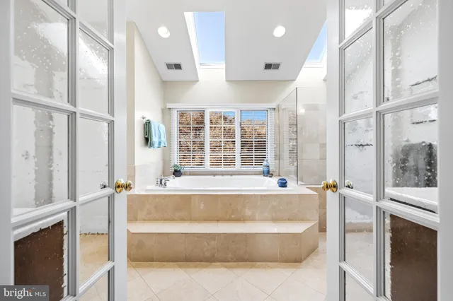 a bathroom with double vanity sinks and a mirror