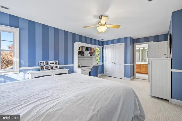 a dining room with a wooden table and chairs
