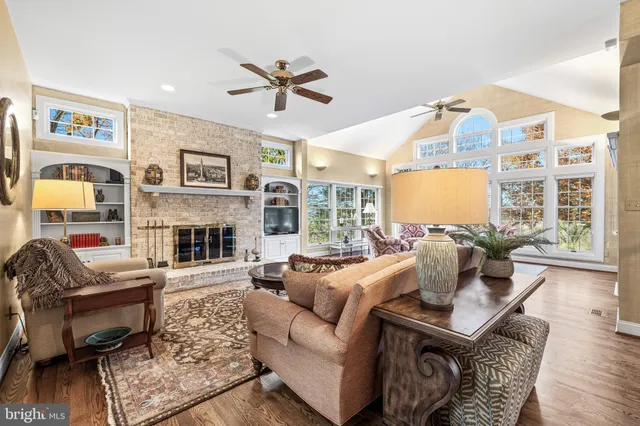 a living room with furniture fireplace and a large window