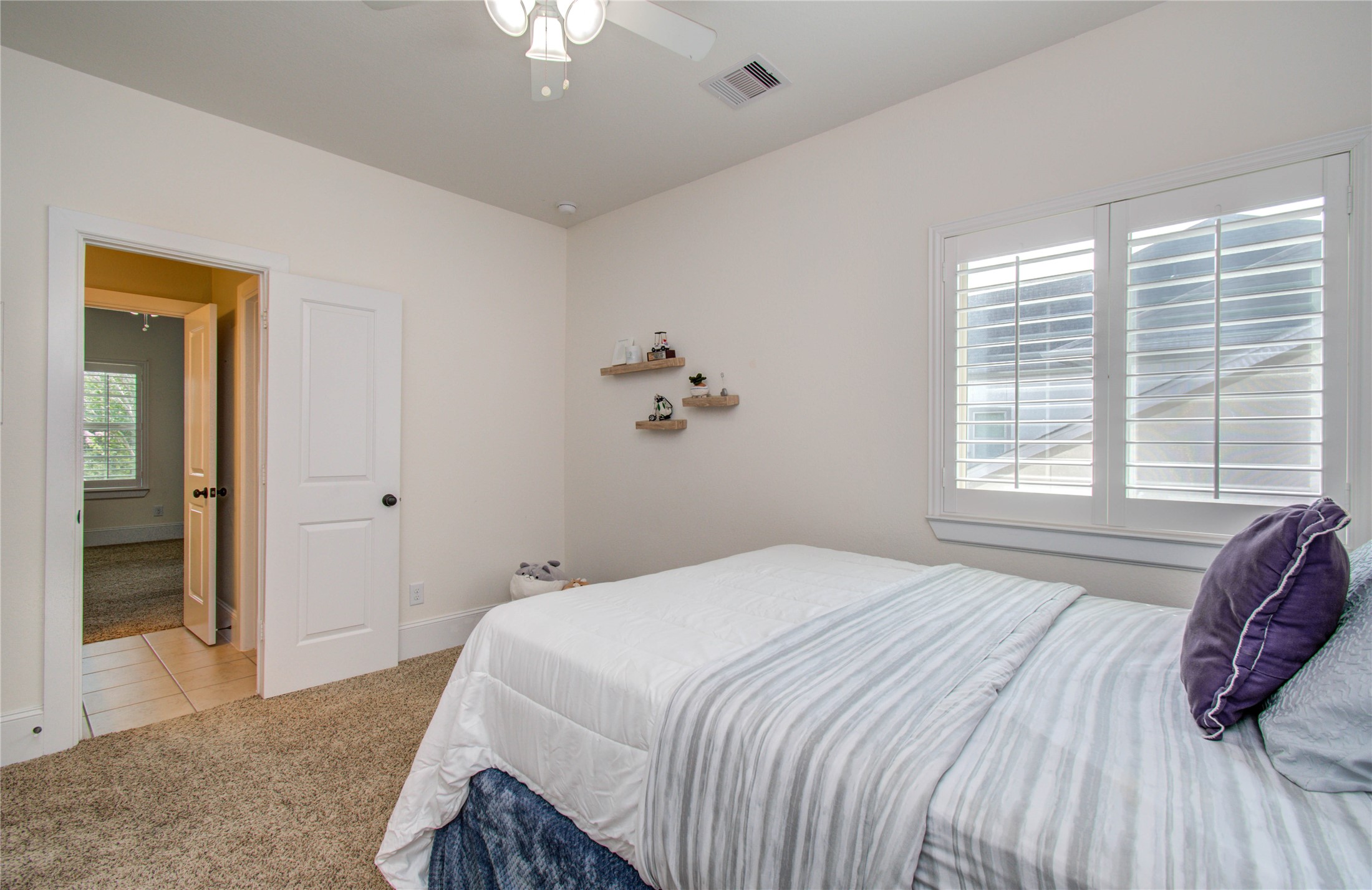 28627 Rolling Ridge Drive Katy, TX 77494 - Photo 32 of 44 a bedroom with a bed and a chandelier