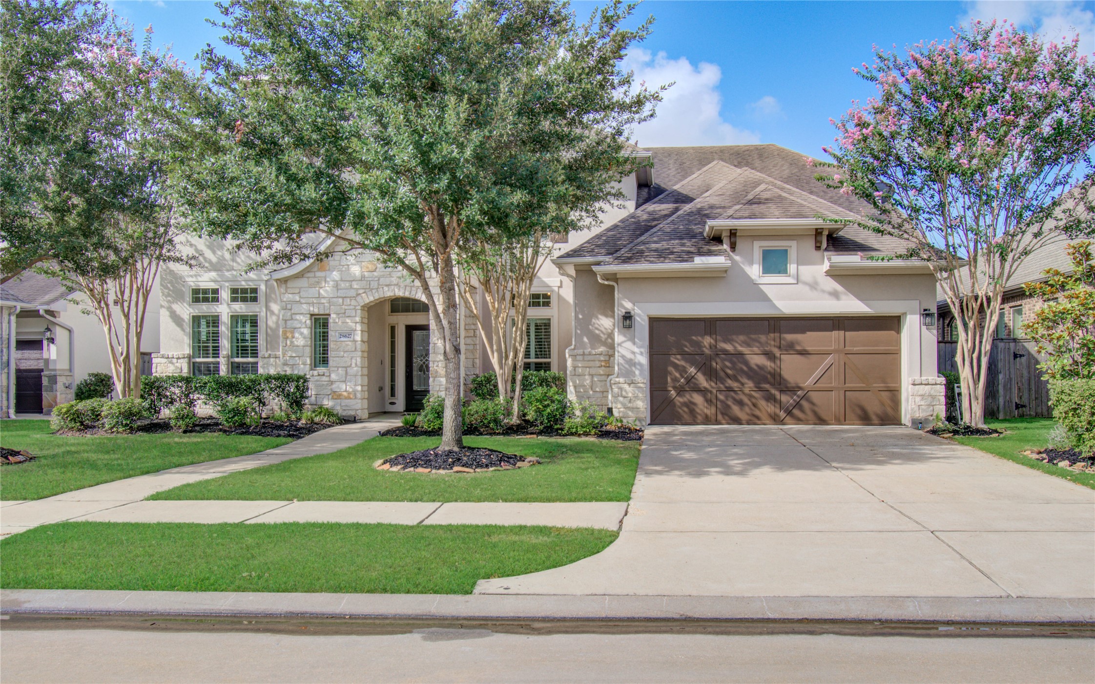 28627 Rolling Ridge Drive Katy, TX 77494 - Photo 8 of 44 a front view of a house with a garden and trees