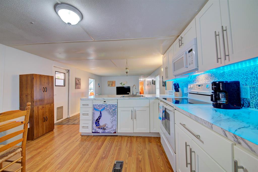 6427 West Richard Drive Weeki Wachee, FL 34607 - Photo 14 of 35 a kitchen with stainless steel appliances granite countertop a sink and cabinets