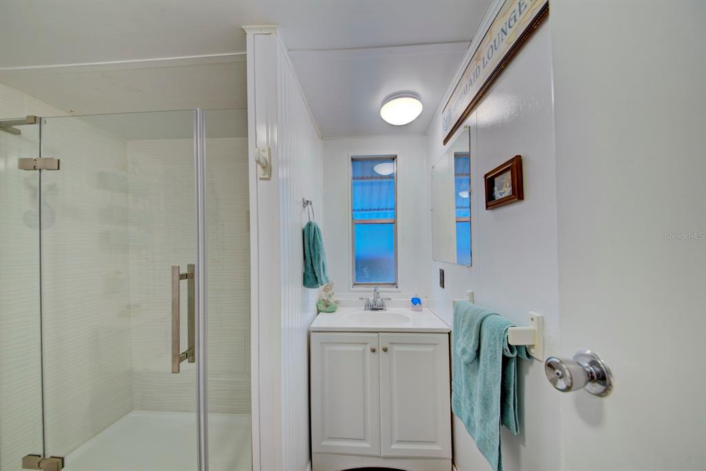 6427 West Richard Drive Weeki Wachee, FL 34607 - Photo 16 of 35 a bathroom with a sink vanity and mirror