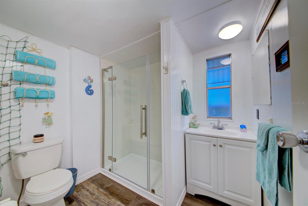 6427 West Richard Drive Weeki Wachee, FL 34607 - Photo 17 of 35 a bathroom with a sink a toilet and shower