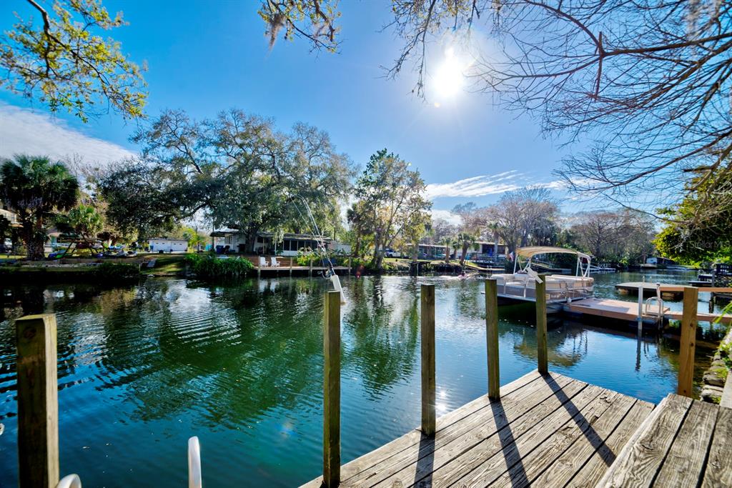 6427 West Richard Drive Weeki Wachee, FL 34607 - Photo 2 of 35 a view of a lake with boats and trees in the background