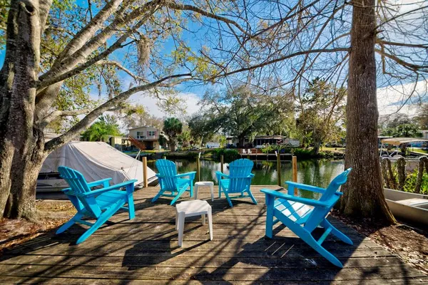 a blue swimming pool with outdoor seating and yard